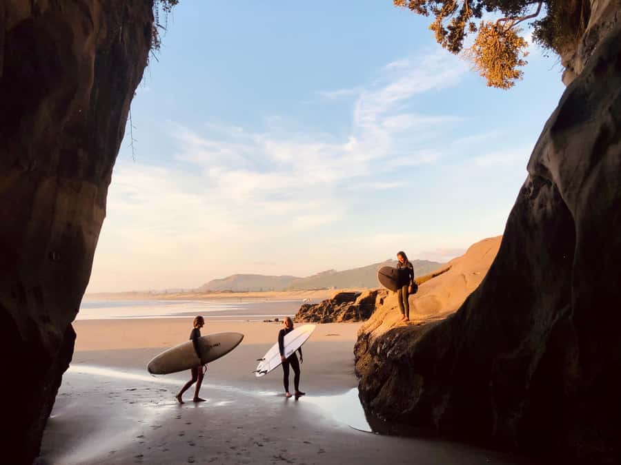 Auckland: Group Surfing Lesson with Muriwai Surf School - What happens when you finally hit the water: wave checks, picking rides, and feedback on your pop-up