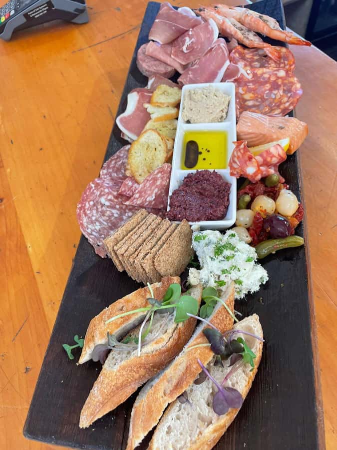 Waiheke: Scenic Taste and Graze Tour with Wine, Whisky, Beer - Mudbrick Restaurant and Vineyard: wine tasting with Rangitoto in view